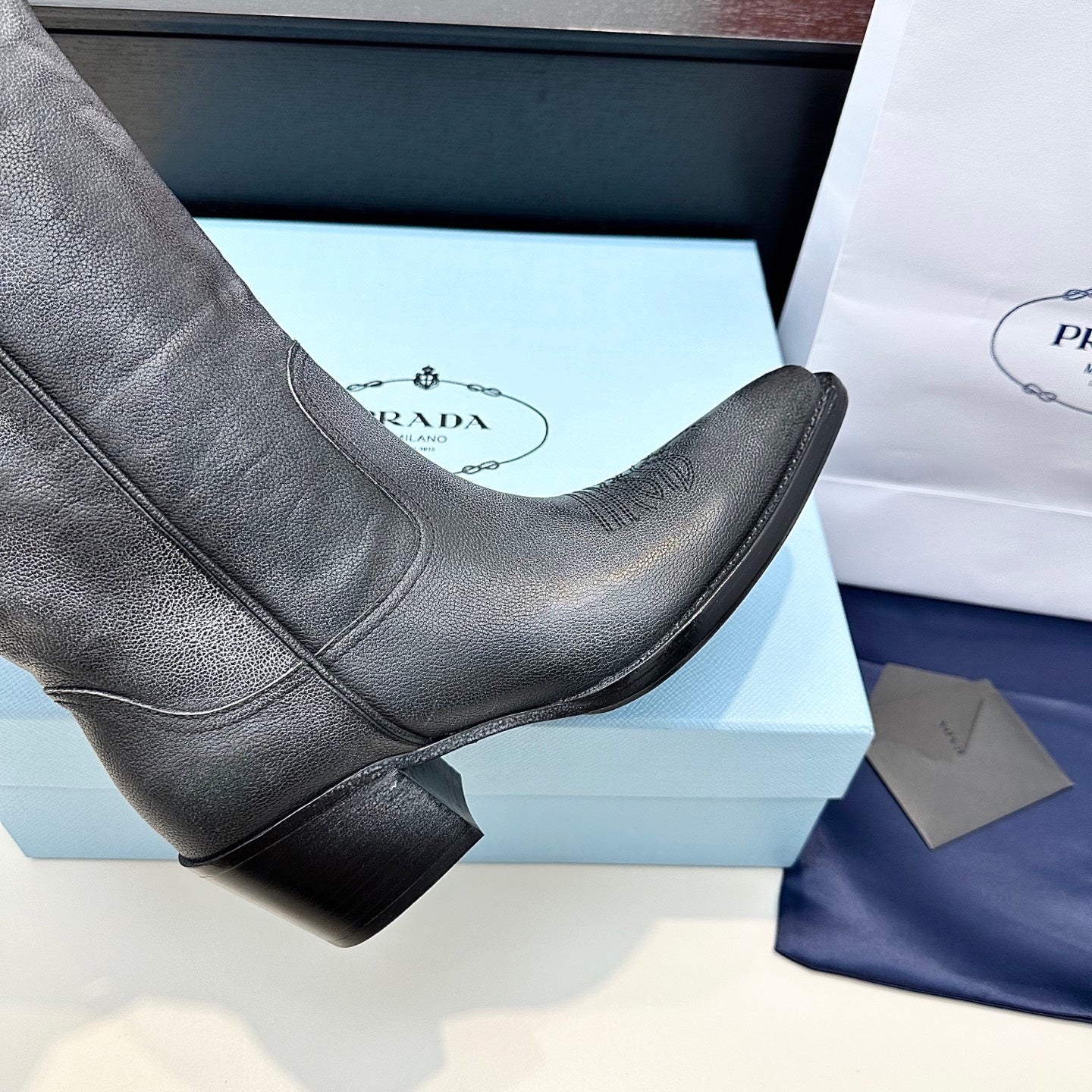 PRADA 25S POINTED-TOE LOW-CUT BOOTS IN BLACK COWHIDE
