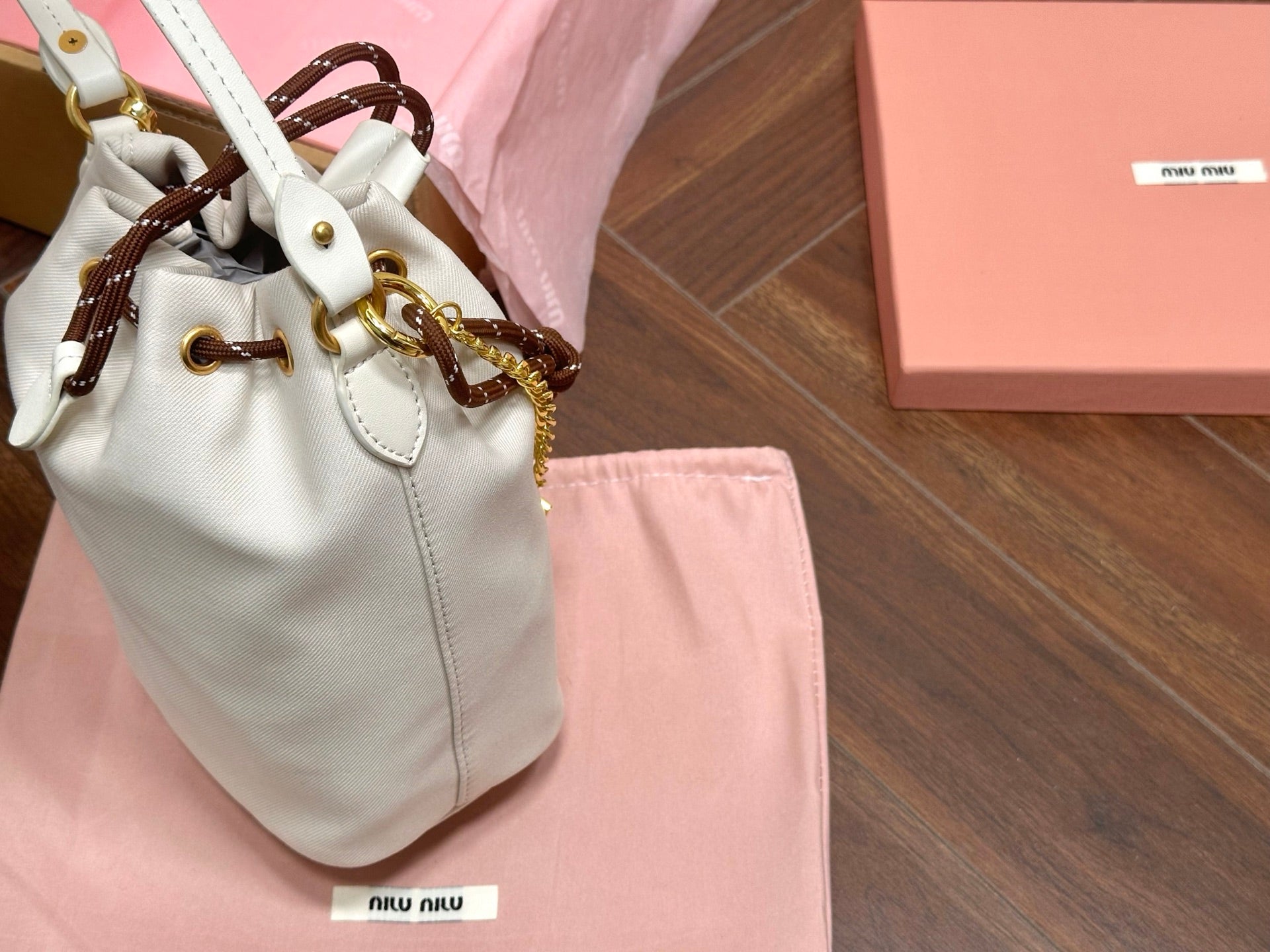 MIU MIU DRAWSTRING BUCKET BAG 21 IN WHITE CANVAS GOLD HARDWARE