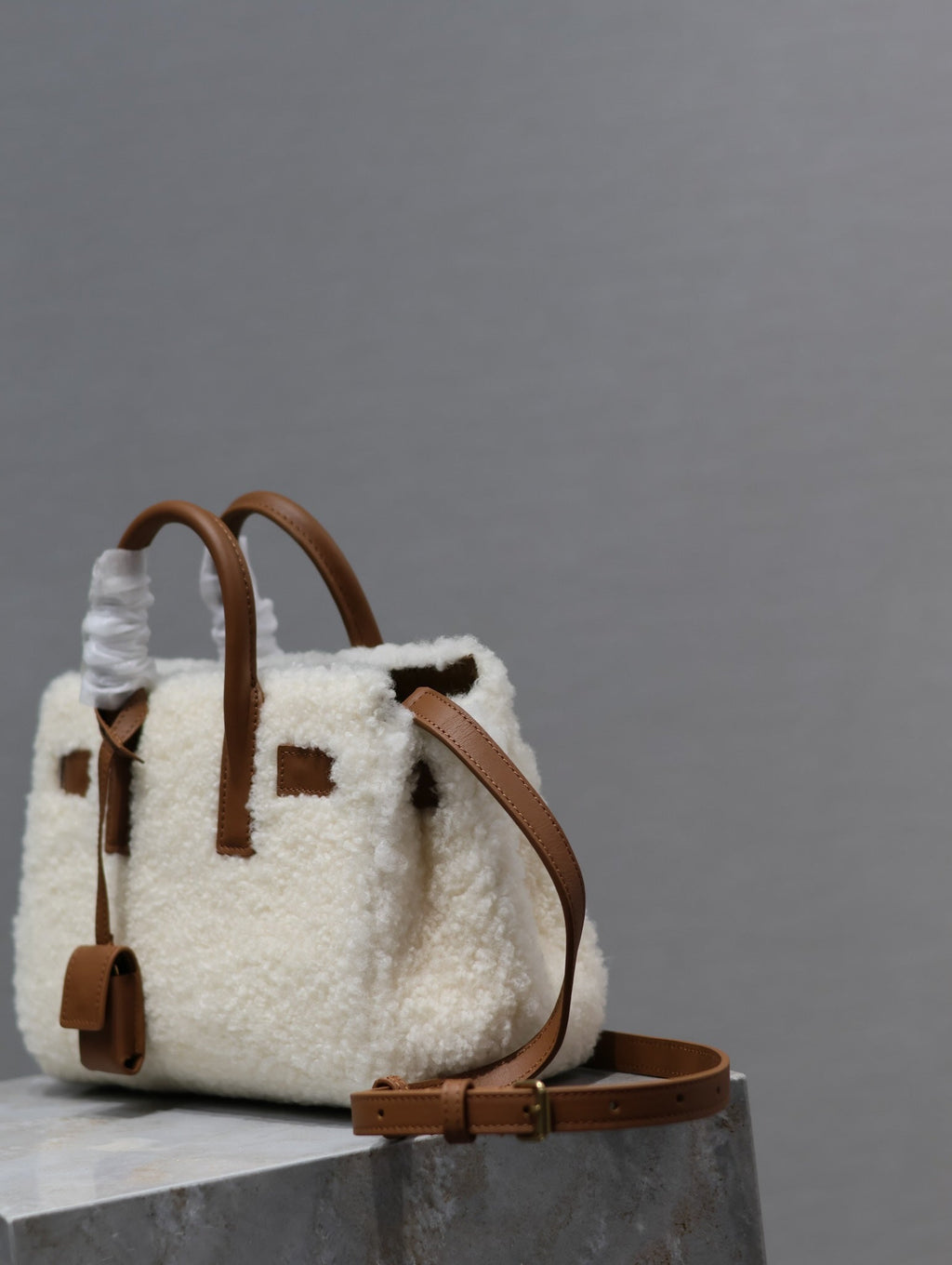 SAINT LAURENT SAC DE JOUR 22 IN WHITE SHEARLING AND BROWN CALFSKIN TRIM