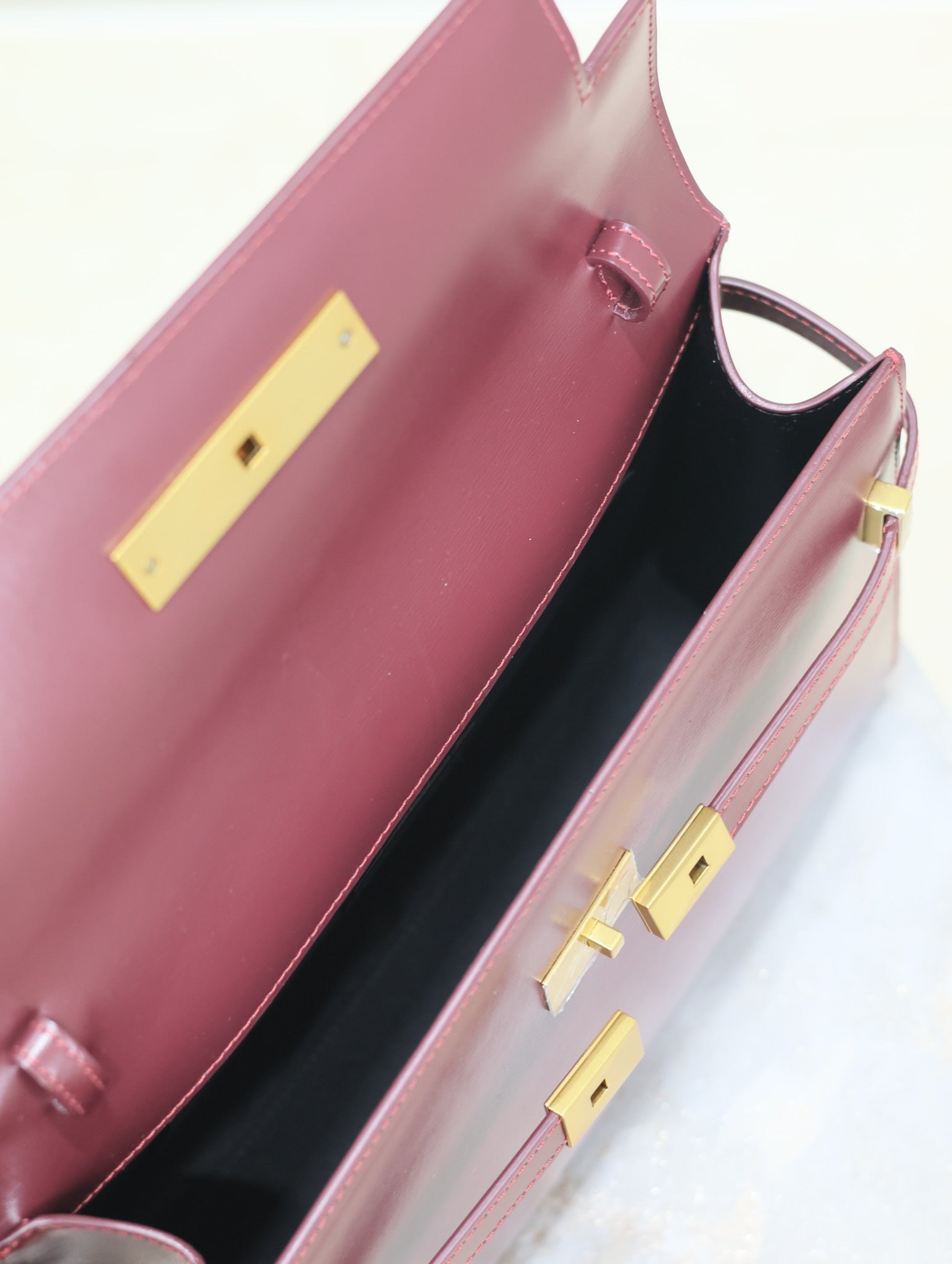 SAINT LAURENT MANHATTAN MEDIUM 29 IN WINE RED SMOOTH CALFSKIN GOLD BUCKLE