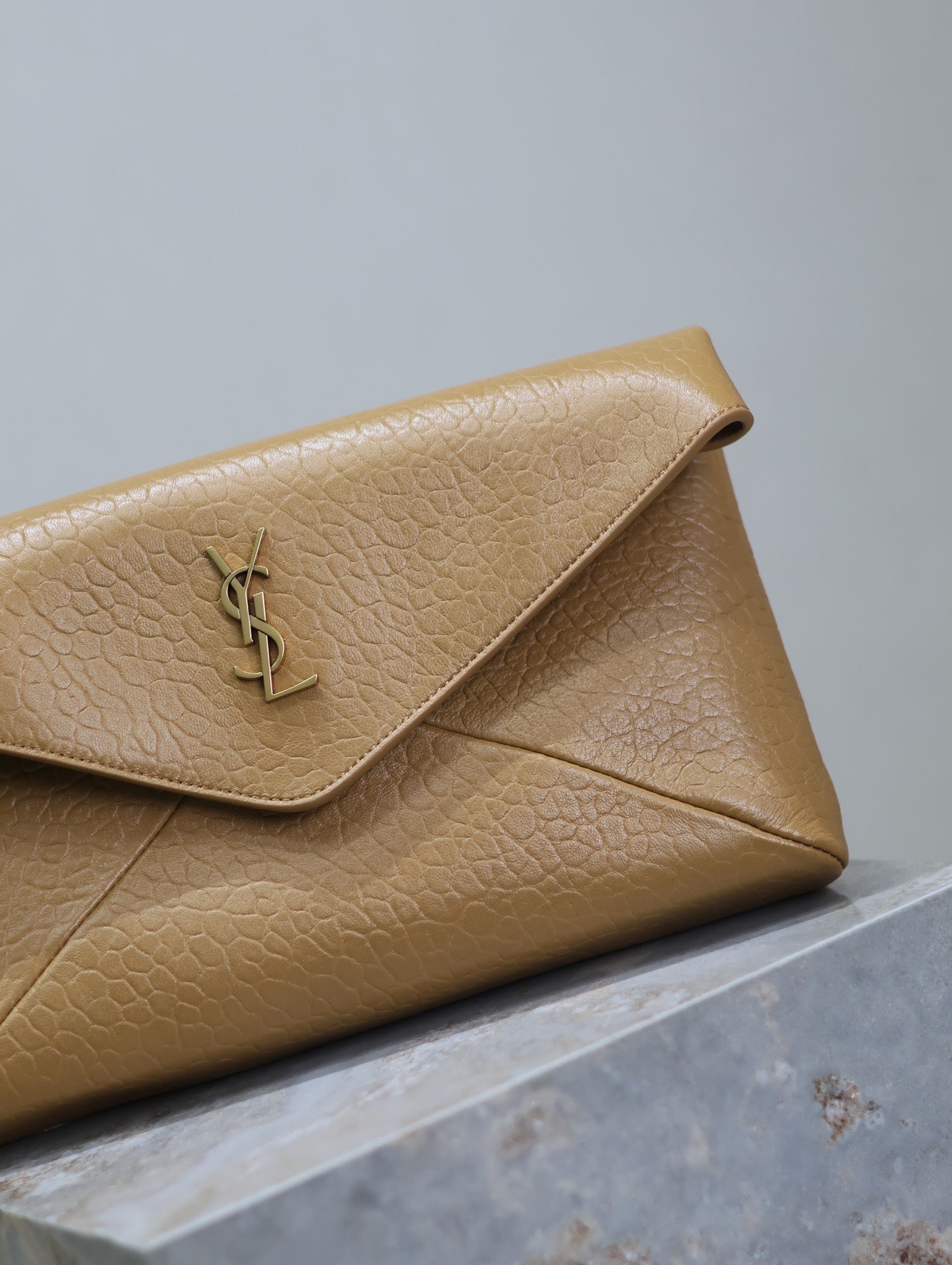 SAINT LAURENT ENVELOPE CLUTCH 29 IN EARTHY YELLOW LAMBSKIN COPPER LOGO