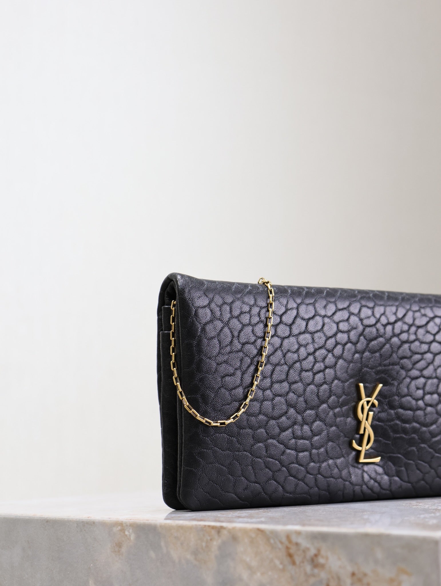 SAINT LAURENT CALYPSO POUCH 24 IN BLACK ELEPHANT TEXTURED LAMBSKIN GOLD LOGO