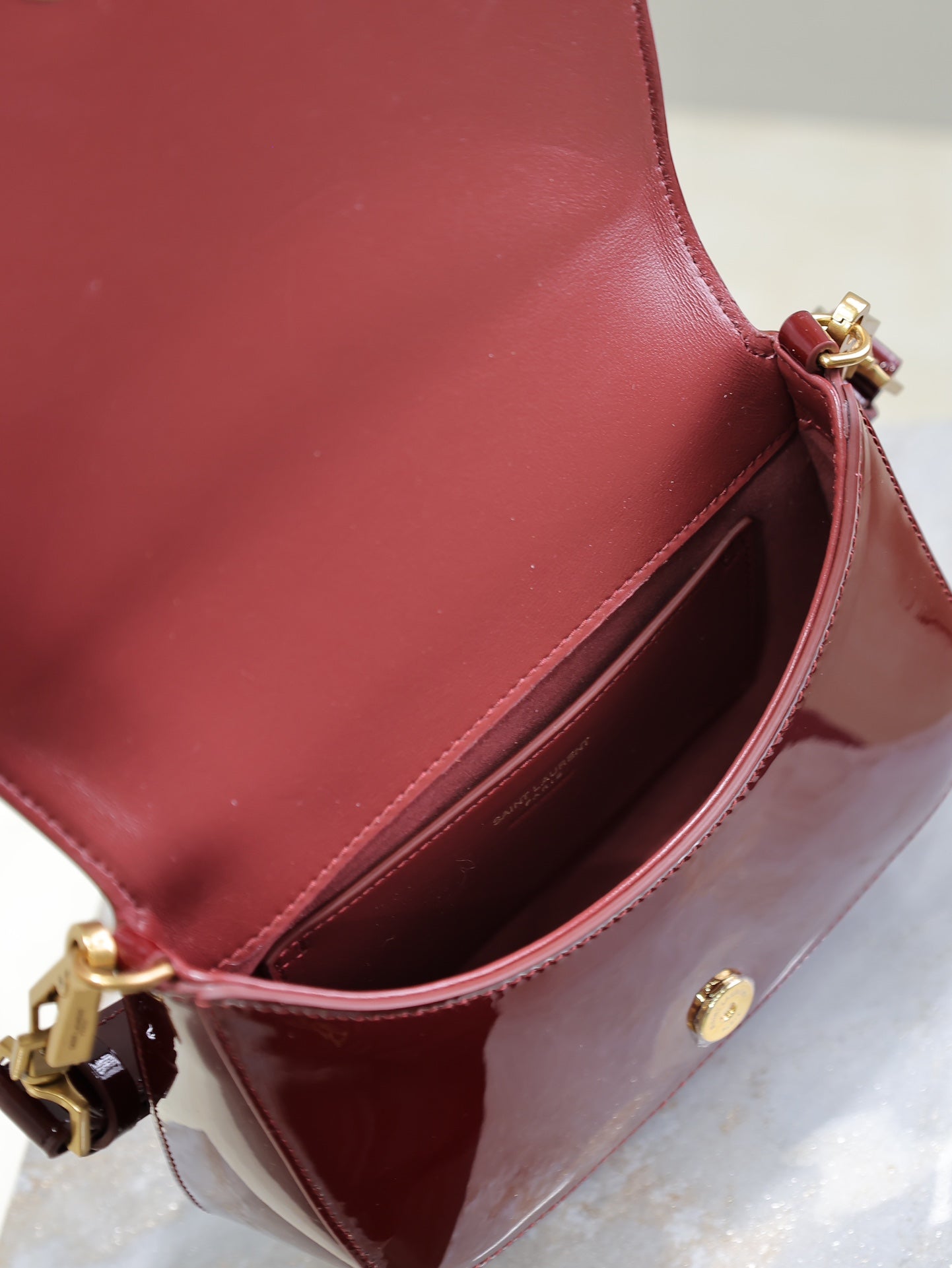SAINT LAURENT VOLTAIRE SADDLE BAG 21 IN BORDEAUX RED PATENT CALFSKIN