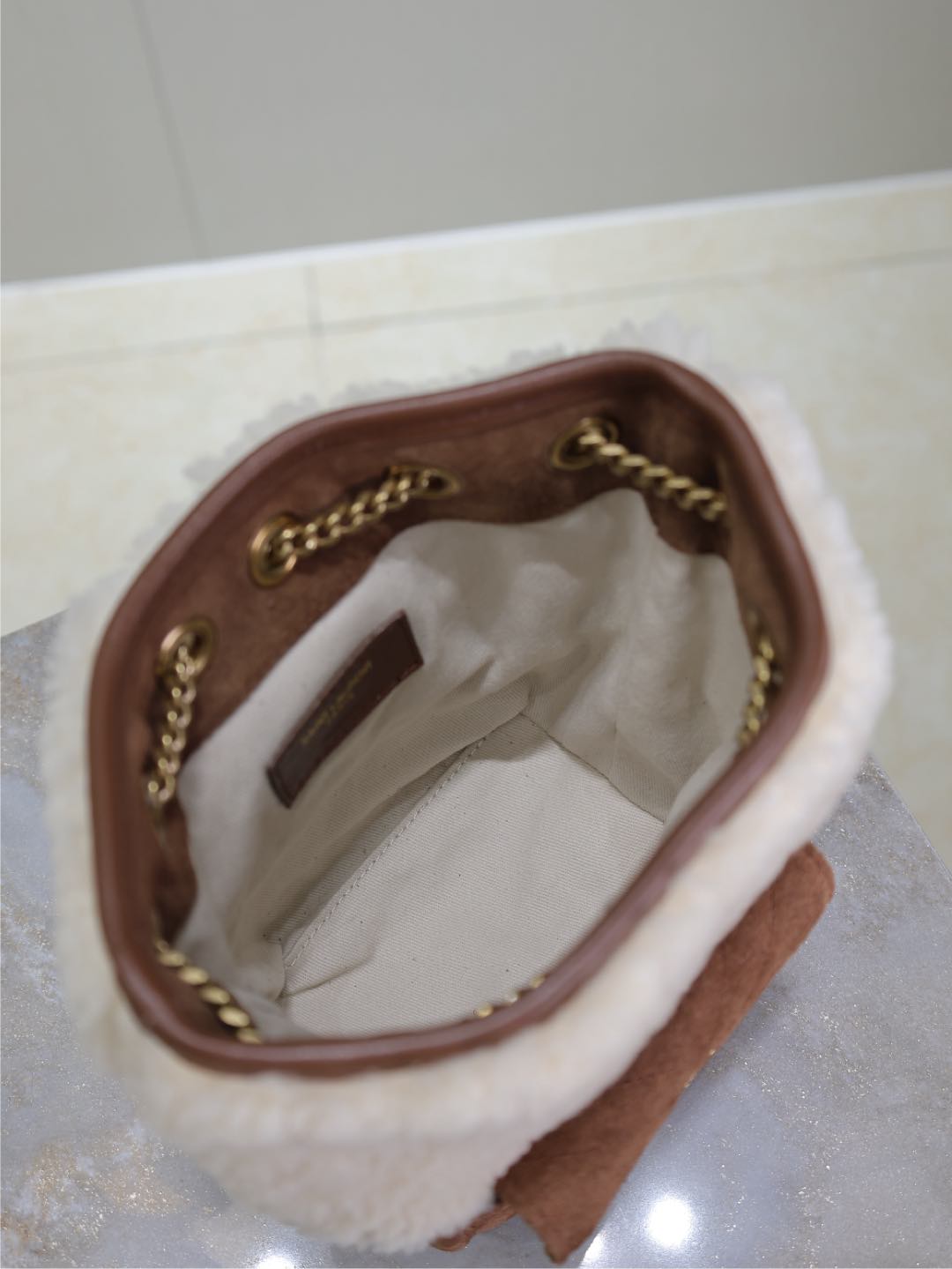 SAINT LAURENT JOE MINI BUCKET BAG 19 IN WHITE SHEARLING AND BROWN SUEDE